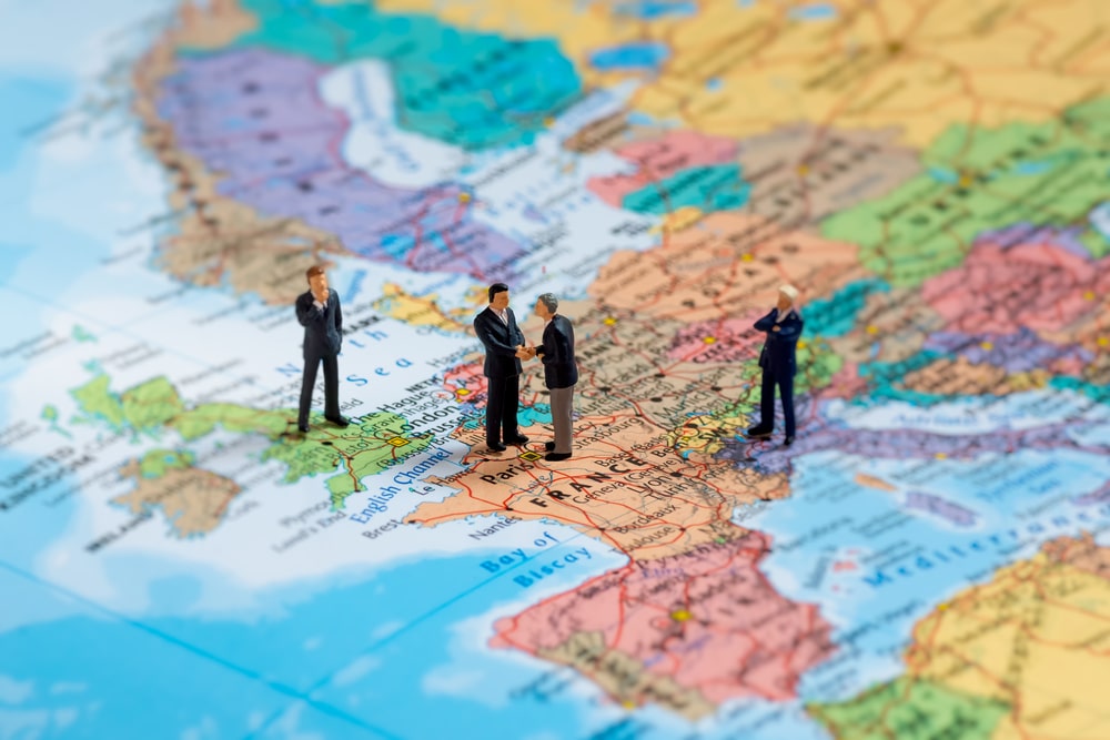 small figures walking on a map