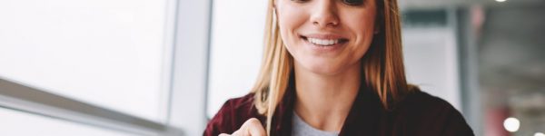 Woman smiling while reading a CV