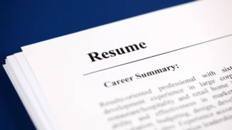 A close up of a resume on a blue background.