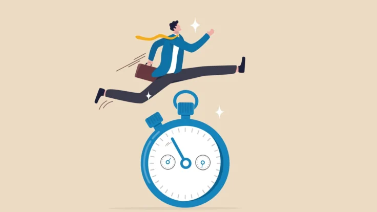A businessman jumping over a stopwatch.