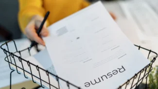 A woman is holding a paper in a basket.
