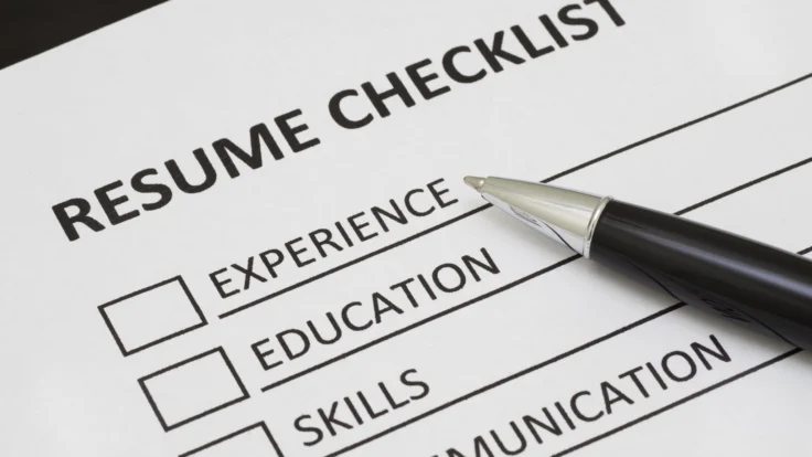A pen is placed on top of a resume checklist.